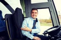 Happy driver inviting on board of intercity bus Royalty Free Stock Photo