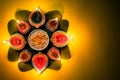 Happy Dussehra. Clay Diya lamps lit during Dussehra with yellow flowers, green leaf and rice on yellow pastel background. Dussehra Royalty Free Stock Photo