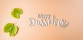 Happy Dussehra, Green leaf on orange pastel background. Dussehra Indian Festival concept