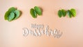 Happy Dussehra. Green leaf on orange pastel background. Dussehra Indian Festival concept