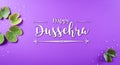 Happy Dussehra. Green leaf and rice with the text on purple pastel background. Dussehra Indian Festival concept