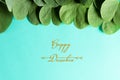 Happy Dussehra. Yellow flowers, green leaf and rice on blue pastel background. Dussehra Indian Festival concept