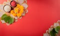 Happy Dussehra. Yellow flowers, green leaf and rice on red background. Dussehra Indian Festival concept