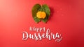 Happy Dussehra. Yellow flowers, green leaf and rice on red background. Dussehra Indian Festival concept