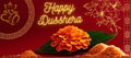 Happy Dusshera. Decorative Dusshera Greeting background with Marigold Flower, Mango Leaves and Rice