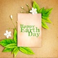 Happy Earth Day paper sheet with fresh spring green leafs borde