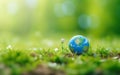 Happy Earth day poster with a transparent globe. Photorealistic sphere in green forest grass. 3d render illustration. Close up, Royalty Free Stock Photo