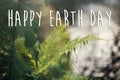 Happy earth day text, concept. beautiful fern leaf and moss in Royalty Free Stock Photo