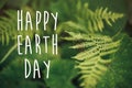 Happy earth day text, concept. beautiful fern leaf and moss in Royalty Free Stock Photo