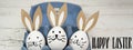 Happy Easter background banner panorama greeting card -Close-up from colorful painted eggs / easter bunnies in blue egg carton on Royalty Free Stock Photo