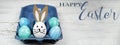 Happy Easter background banner panorama greeting card -Close-up from colorful painted eggs / easter bunnies in blue egg carton on Royalty Free Stock Photo