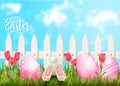 Happy Easter background with fence and eggs in grass Royalty Free Stock Photo