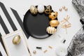 Happy Easter background with golden decorated eggs on black plate isolated on white background. Trendy flat lay easter. Royalty Free Stock Photo