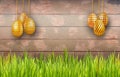 Happy Easter background with golden eggs on white rustic wooden background with green grass and copy space. Royalty Free Stock Photo