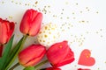 Happy Easter background. Handpainted white egg with gold dots, red tulips and paper heart against of small stars Royalty Free Stock Photo