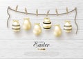 Happy Easter background with realistic golden shiny eggs on rope with clothespins. Design layout for invitation