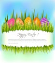 Happy Easter background with set of colorful eggs in grass and copy space.