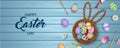 Happy easter banner with colorful eggs, flowers and tempera tubes on wooden background