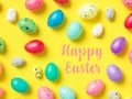 Happy Easter Banner with multiple coloured Easter eggs on a Yellow background Royalty Free Stock Photo