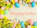 Happy Easter Banner with multiple coloured Easter eggs surrounded by spring flowers Royalty Free Stock Photo