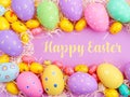 Happy Easter Banner with multiple coloured Easter eggs surrounded by straw Royalty Free Stock Photo