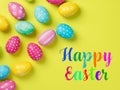 Happy Easter Banner with multiple coloured Easter eggs on a Yellow background