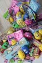 Happy easter basket filled with easter candy, marshmallow peeps, chocolate bunnies, jellybeans, egg people