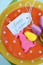 Happy Easter bright color orange, yellow and green polka dot theme table place setting Royalty Free Stock Photo