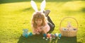 Happy easter bunny child boy painting eggs. Spring kids holidays concept.