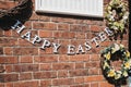 Happy Easter bunting against brick wall outside a shop in Sheringham, Norfolk, UK