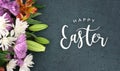 Happy Easter Calligraphy Holiday Script With Colorful Spring Flowers Over Blackboard Background Texture Royalty Free Stock Photo