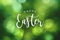 Happy Easter Calligraphy Text Over Green Spring Bokeh Background