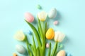 Happy Easter card. Bouquet of tulips and Easter eggs on light blue background Royalty Free Stock Photo