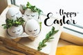 Happy Easter card. Cute Easter eggs with a painted face in a spring wreath with copy space for text. Happy easter Royalty Free Stock Photo