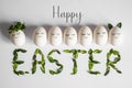 Happy Easter card. Cute Easter eggs with a painted face in a spring wreath with copy space for text. on white background Royalty Free Stock Photo