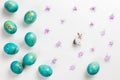 Happy easter card. Stylish minimalistic composition of turquoise with gold easter eggs on a white background. Figurine