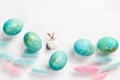 Happy easter card. Stylish minimalistic composition of turquoise with gold easter eggs on a white background. Figurine