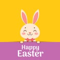 Happy Easter. Easter cartoon smiling bunny in a red bow tie is looking out of the hole and holding the text place Royalty Free Stock Photo