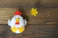 Happy Easter: Chicken toy holding spring flower Royalty Free Stock Photo