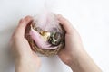 Happy Easter: a child holds a nest with eggs in his hands