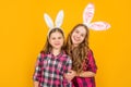 happy easter children in bunny ears on yellow background