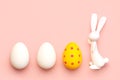Happy Easter. Close-up of three easter eggs next to easter bunny with copy space for text Royalty Free Stock Photo