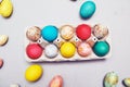 Happy easter. Colored eggs on gray concrete. Flowering, fur-seal willow, on an abstract gray background. Multicolored paints,