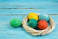 Happy Easter.Colorful shiny eggs on wooden table background. wreath woven from the vines. Copy space for text. Top view Royalty Free Stock Photo