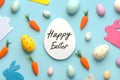 Happy Easter. Composition with colorful easter eggs,easter bunnies and carrotswith a white egg in the center with text Happy Royalty Free Stock Photo