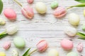 Happy Easter composition. Easter eggs on colored table with yellow Tulips. Natural dyed colorful eggs background top Royalty Free Stock Photo