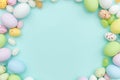 Happy Easter concept. Easter candy chocolate eggs and jellybean sweets isolated on trendy pastel blue background. Simple