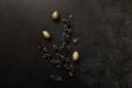 Happy Easter concept. Preparation for holiday. Golden decorated easter eggs willow feather on trendy grunge scratched Royalty Free Stock Photo