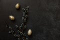 Happy Easter concept. Preparation for holiday. Golden decorated easter eggs willow on trendy grunge scratched dark black shale Royalty Free Stock Photo