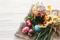 happy Easter concept. stylish painted eggs and easter cake on white rustic wooden background with spring flowers and candle. seas Royalty Free Stock Photo